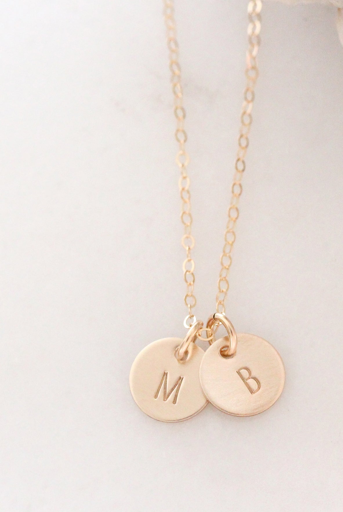 tiny gold disc necklace with initials